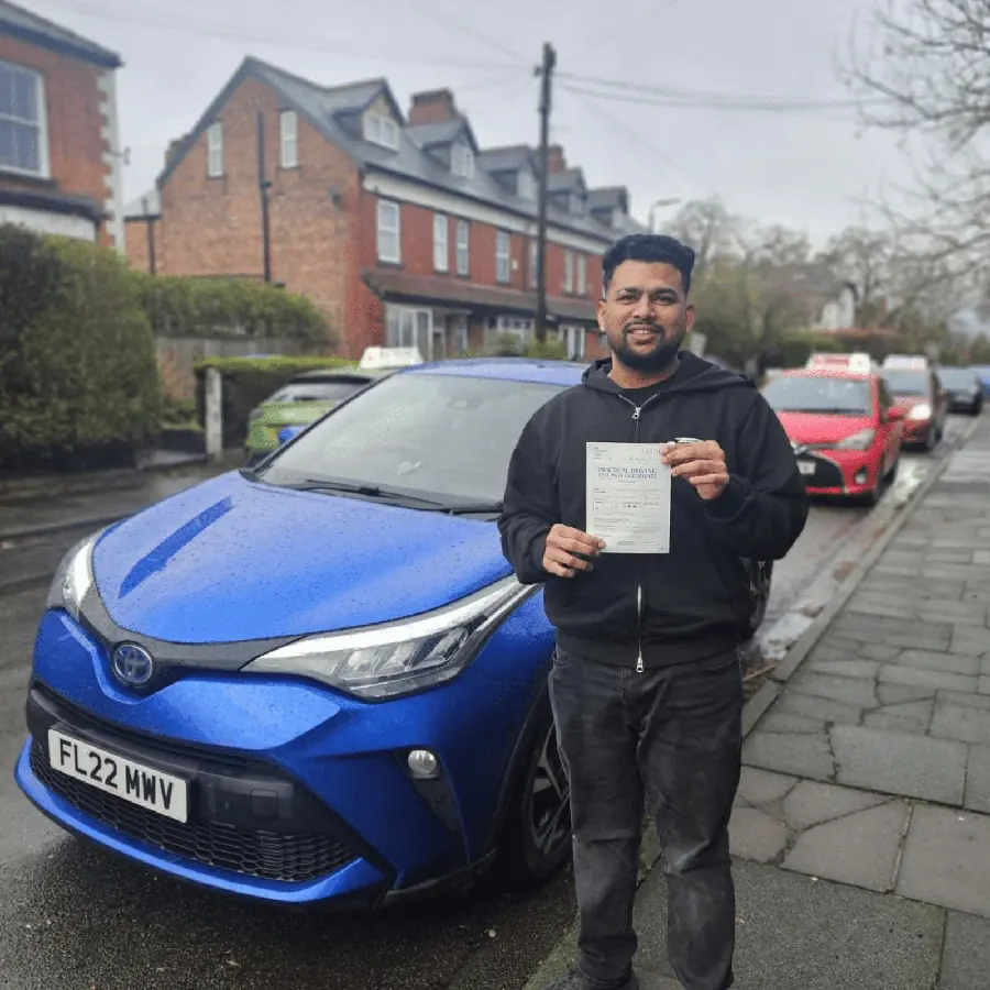 Astra Driving School student holding their driving test pass certificate