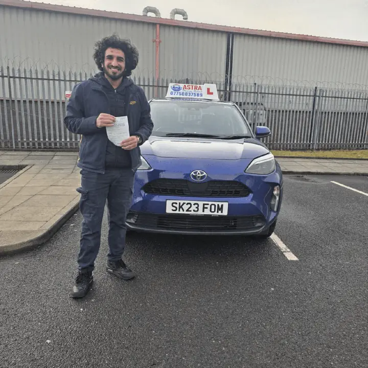 Astra Driving School student holding their driving test pass certificate