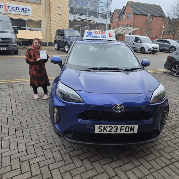 Astra Driving School student holding their driving test pass certificate