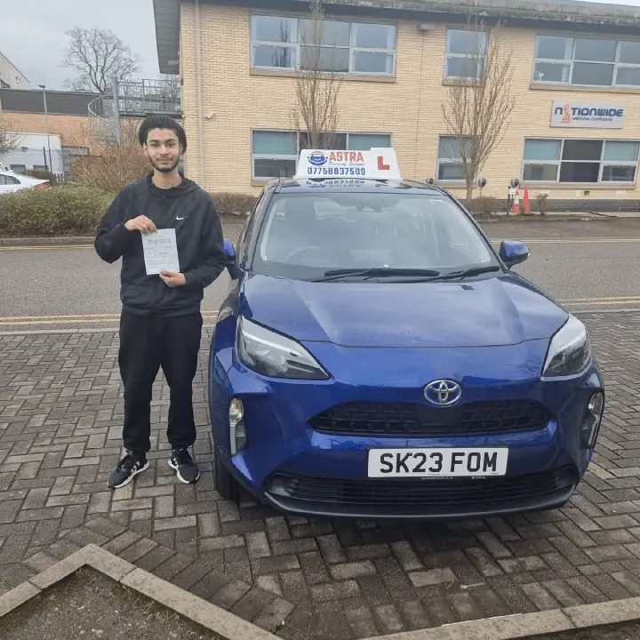 Astra Driving School student holding their driving test pass certificate