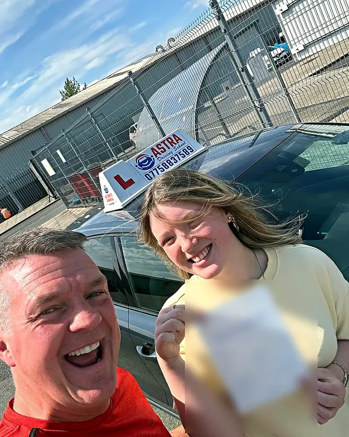Astra Driving School student holding their driving test pass certificate