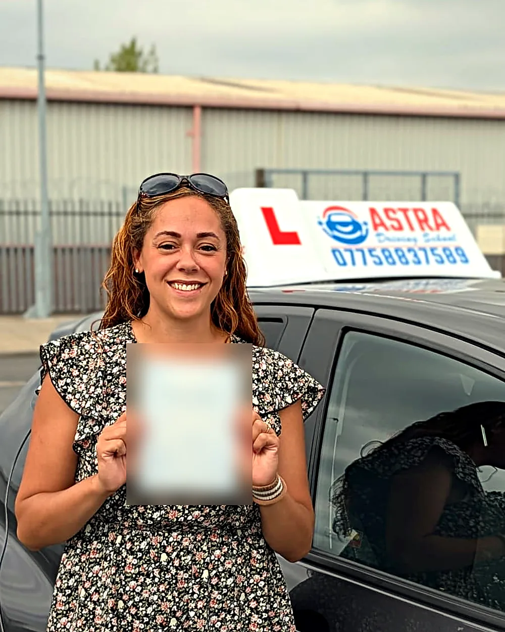 Astra Driving School student holding their driving test pass certificate